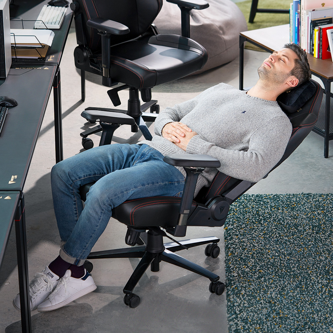 man resting in Secretlab gaming chair, reclined gaming chair