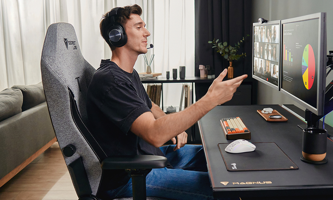 Taking a video call while seated at the MAGNUS Pro desk